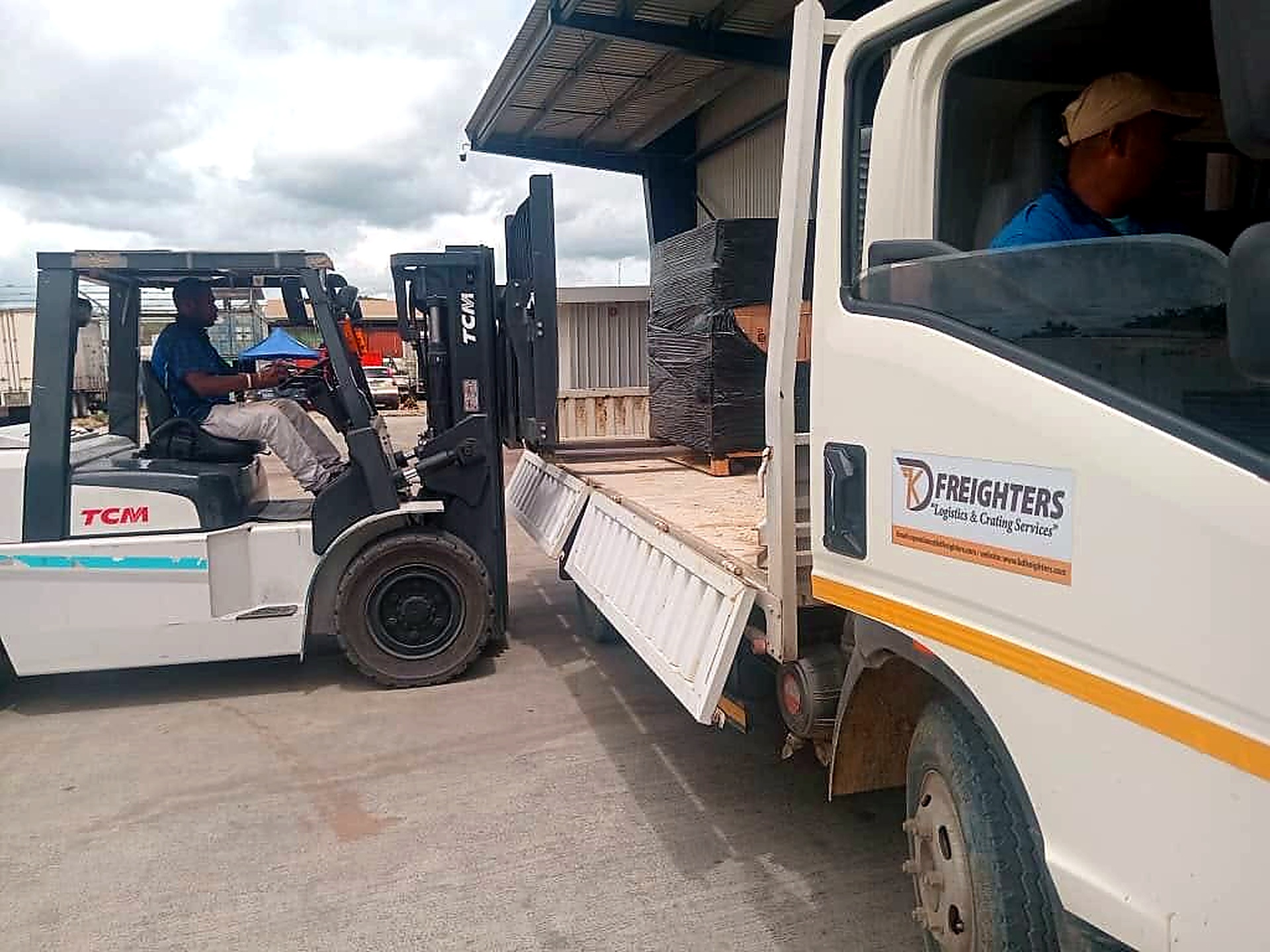KD Freighters forklift loading cargo onto company truck